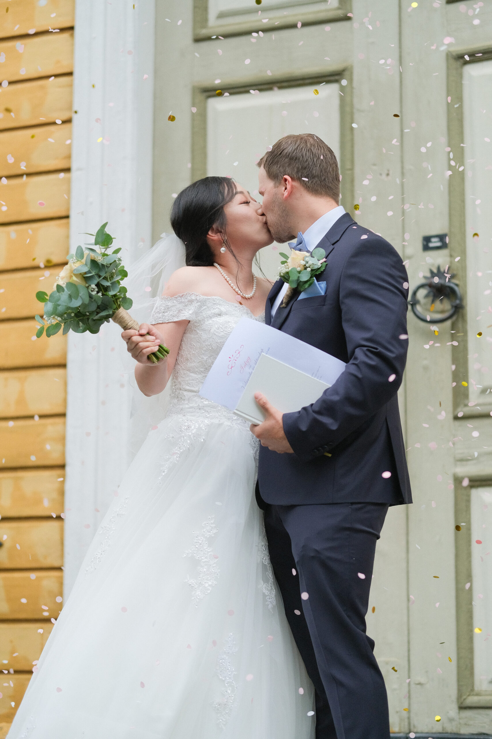 Wedding kiss with confetti
